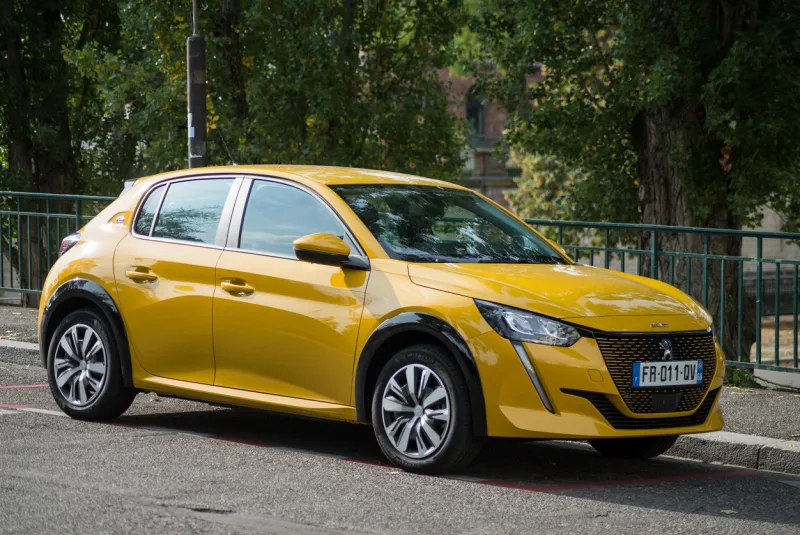 mulhouse - france - 24 september 2020 - profile view of yellow peugeot 208 electric parked in the street