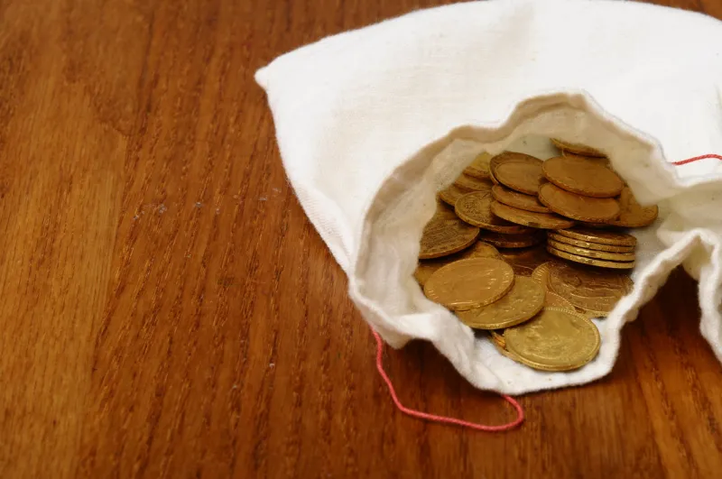 close up of gold french coin, napoleon, on wooden table