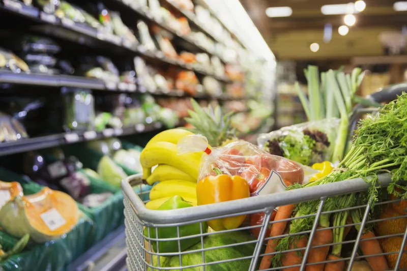 close up of full shopping cart in grocery store