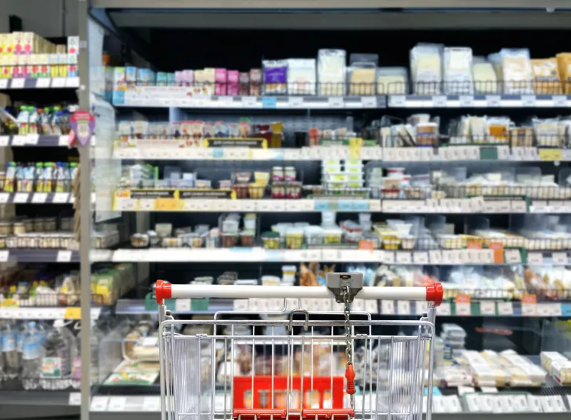 choosing a dairy products at supermarketempty grocery cart in an empty supermarket