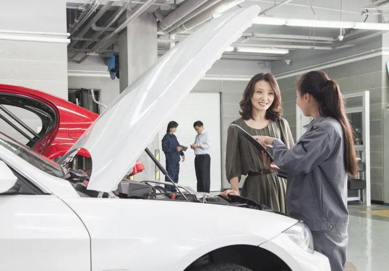mechanics and customers in auto repair shop