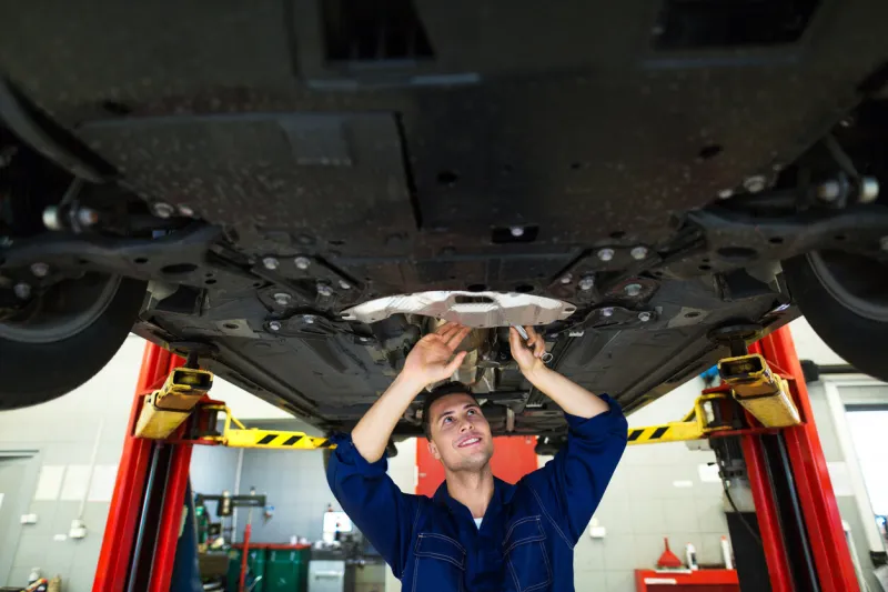 mechanic working on car in auto repair shop