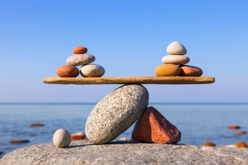 symbolic scale of the stones on sea background concept of harmony and balance work-life, emotional balance