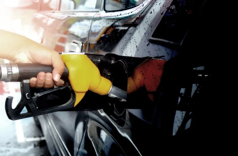 colorful fuel gasoline dispenser with sun flare background