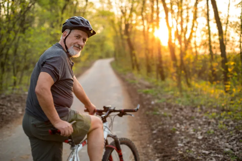 senior man on his mountain bike outdoors (shallow dof, color toned image)