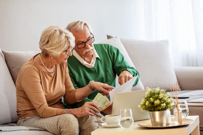 shot of a senior couple working on their finances using a laptop shot of a senior couple looking worried while going through paperwork together at home worried senior couple checking their bills at home