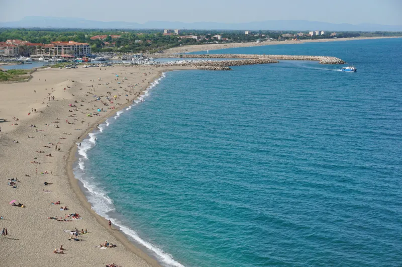 aerial view of the sandy beach le racou in argeles sur mer with the harbor in background, mediterranean sea, roussillon, pyrenees orientales, france