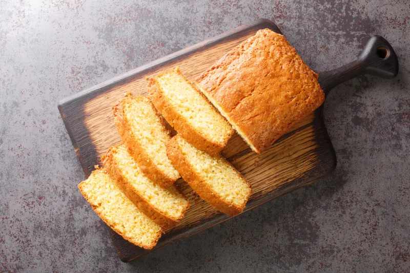 delicious tender madeira biscuit cake close-up on a wooden board on the table horizontal top view from above
