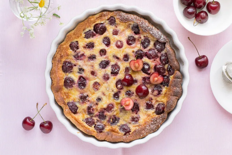 cherry clafoutis on pink background