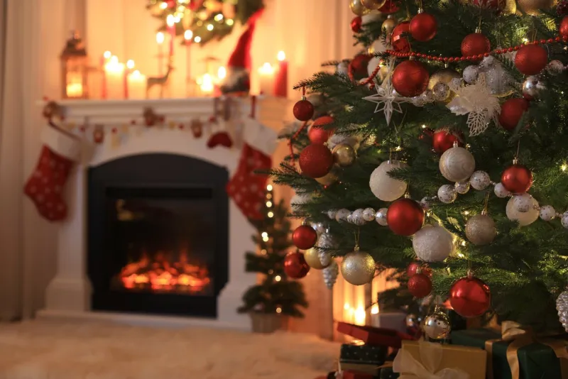 festive living room interior with christmas tree near fireplace