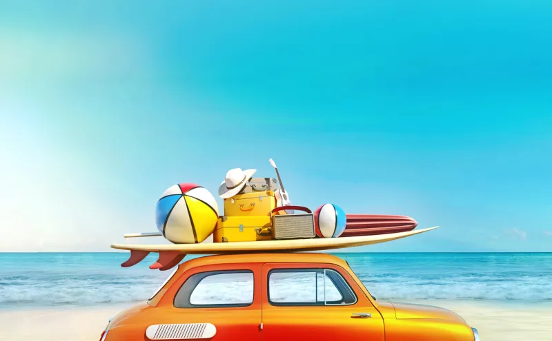 small retro car with baggage, luggage and beach equipment on the roof, fully packed, ready for summer vacation, concept of a road trip with family and friends, dream destination, very vivid colors with dominant blue sky and ocean and bright orange car