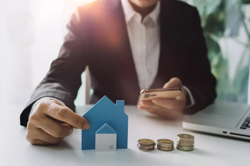 stacking dollars coins with a house modelsave and investment for buy house concept pastel tone