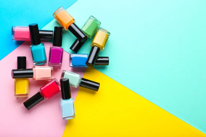 nail polish bottles on colorful background