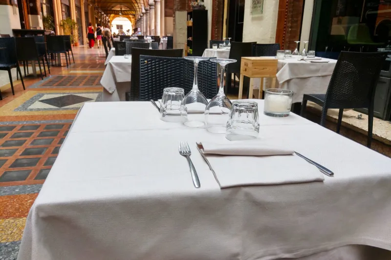 outdoor dining concept in european alley - restaurant table setting for summer dining experience