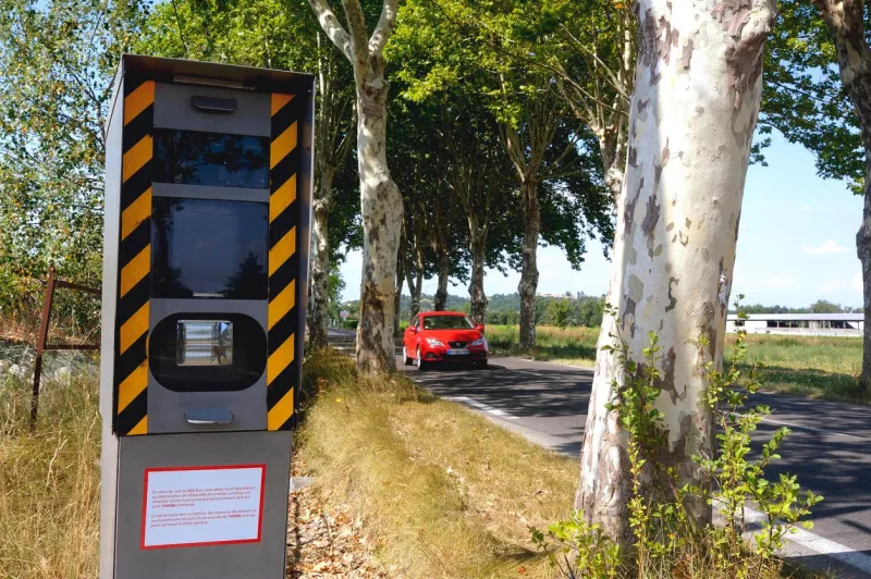 radar on a french road hidden behind an alignment of trees