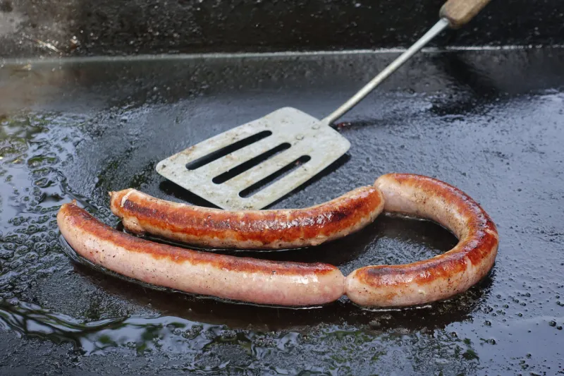 chipolata cooked on a plancha hob