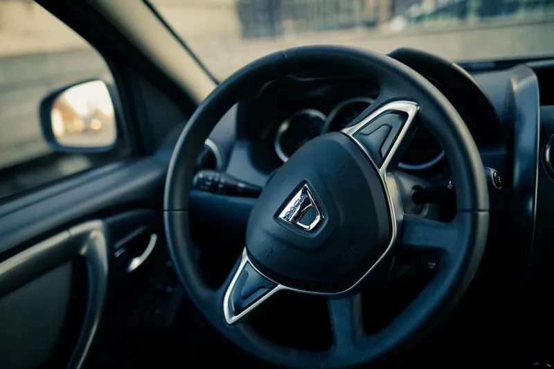bucharest, romania - april 11, 2021  shallow depth of field (selective focus) image with the dacia logo on a duster steering wheel