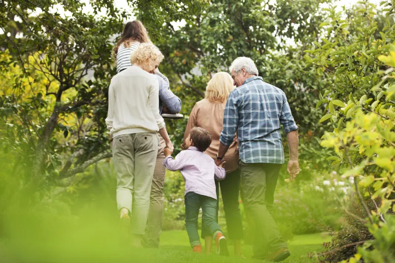 multi-generation family walking in park