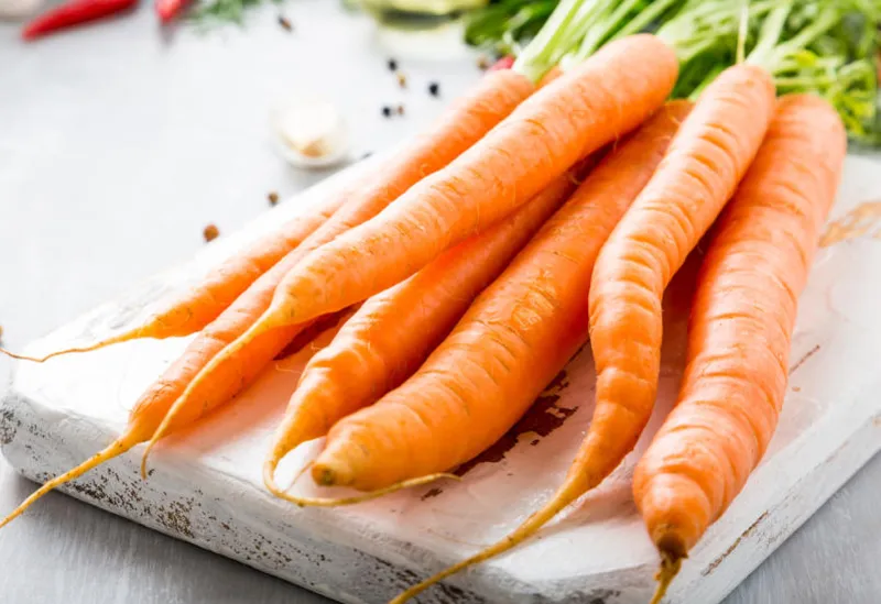 carrots with vegetarian cooking ingredients bio healthy food concept organic vegetables on old wooden cutting board copy space