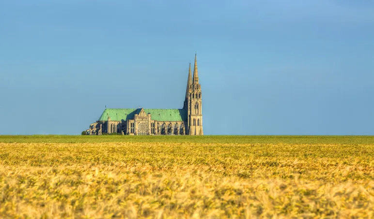 image of the cathedral of our lady of chartres seen from outside of the city above the fields of cereals which surround the localitythis is a very famous gothic cathedral which contains original stained glass from the 13th century