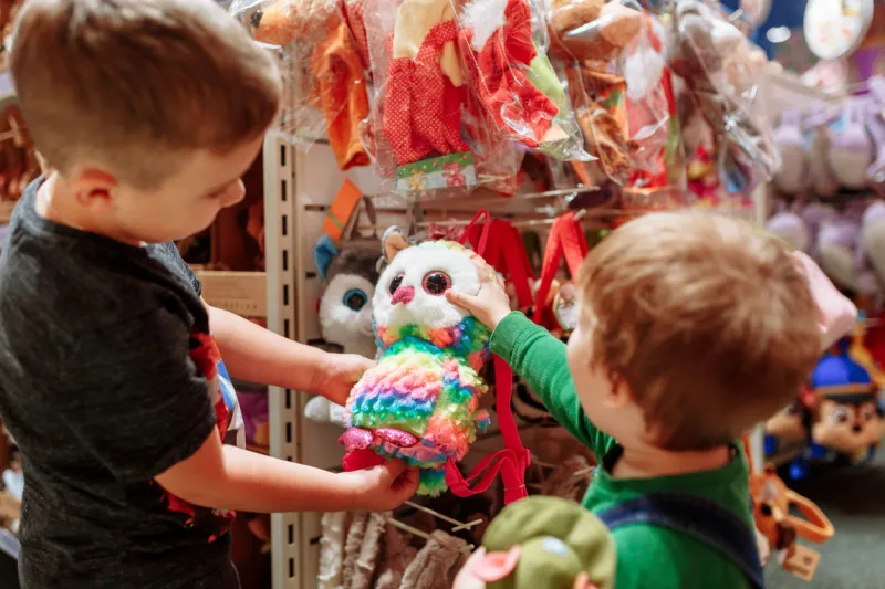 two cute baby boys walking together in mall pair of kid friends holding hands during walk