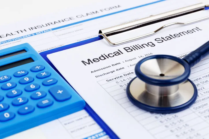 medical bill and health insurance form with calculator
