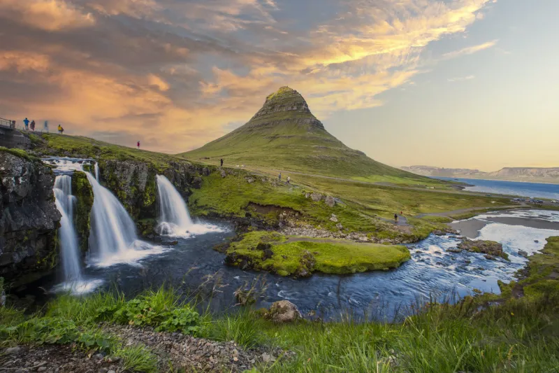the beautiful sunset at kirkjufell waterfall in iceland