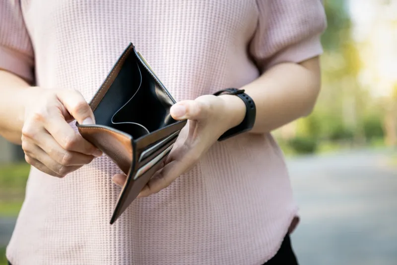 hand of bankrupt girl holding a wallet,hand open an empty wallet,no cash,financial problem,economic depression,effects of the covid-19, asian woman shows her empty money in wallet,unemployment concept