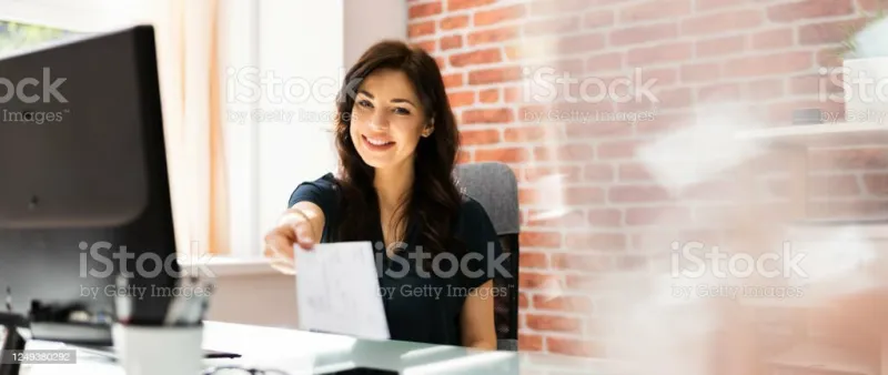 hand giving payroll cheque paycheck in hand