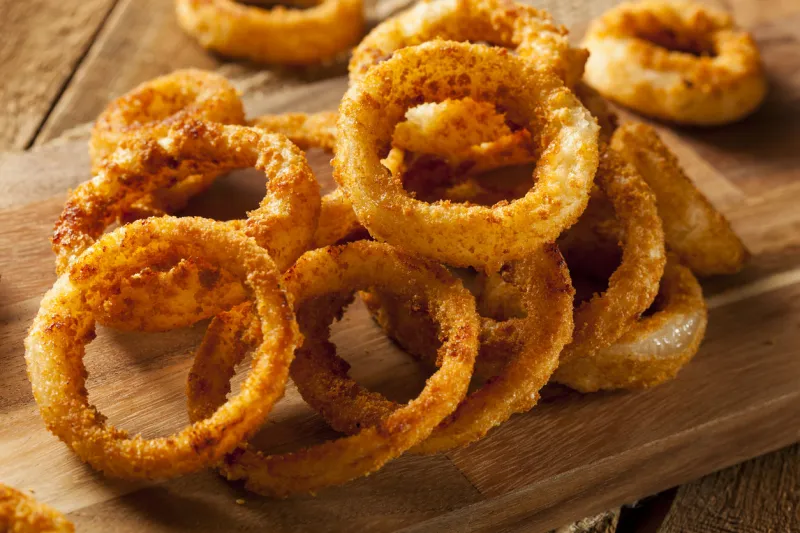 homemade crunchy fried onion rings with ketchup