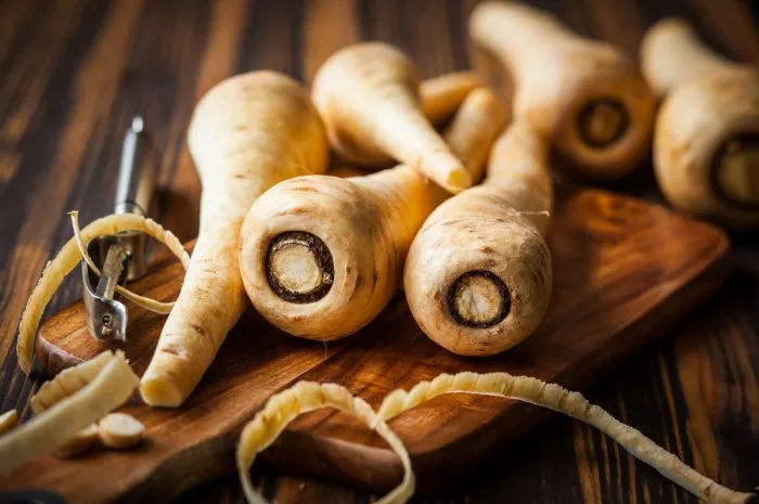 fresh parsnip on wooden table