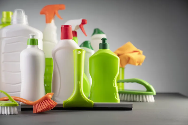 white and green cleaning kit on gray background