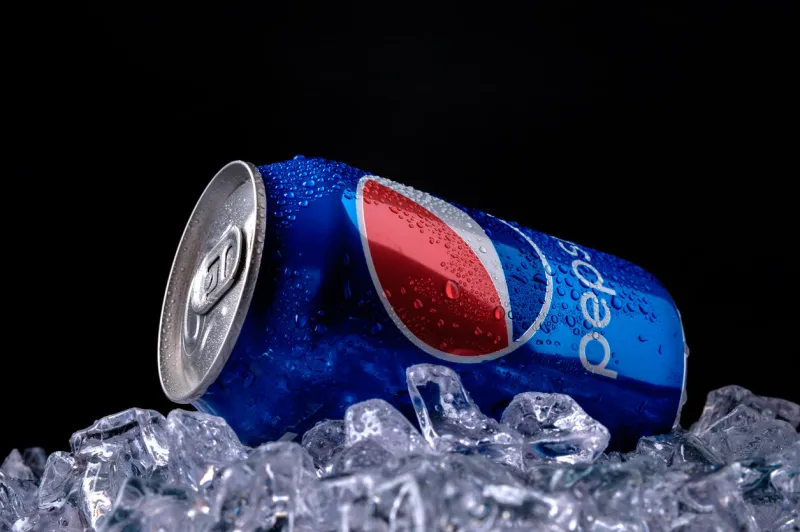 minsk, belarus - august 16, 2015  minsk, belarus - august 16, 2015  can and glass of pepsi cola on ice pepsi is a carbonated soft drink that is produced and manufactured by pepsico created and developed in