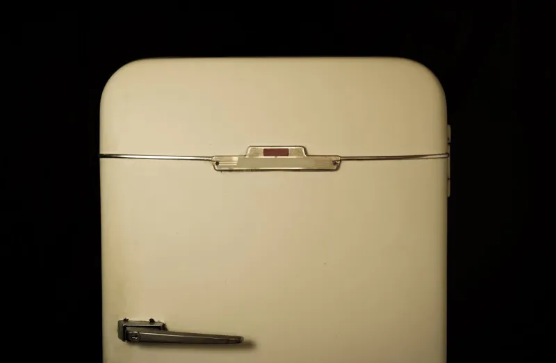 very old fridge on a black background