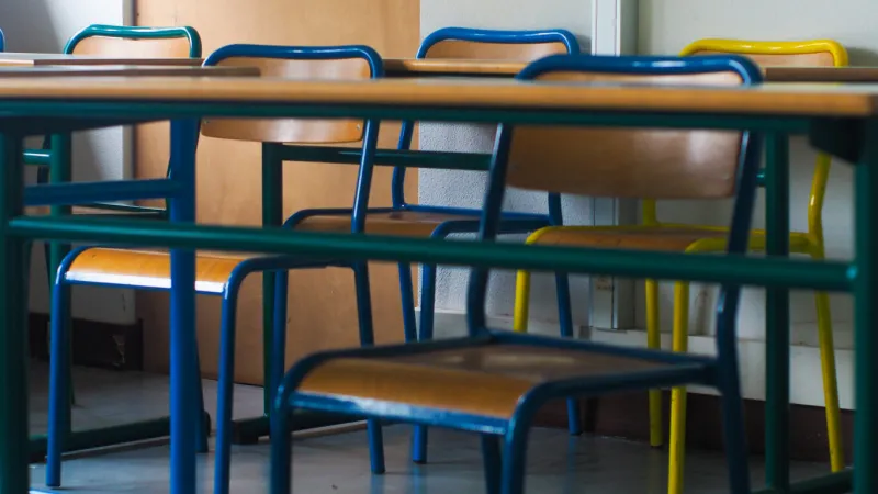 rows of chairs in a classroom, during the covid-19 pandemic