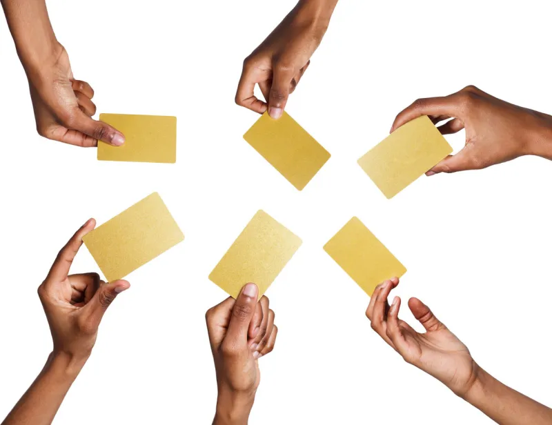 set of african-american man's hands holding golden empty business or credit cards with copy space isolated at white background
