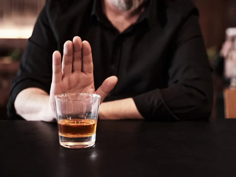 man refuses or rejects to drink alcohol at the pub alcohol addiction treatment, sobriety and drinking problem