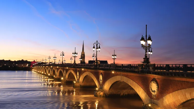 beautiful view of the pont de pierre with sunset sky scene which the pont de pierre crossing garonne river