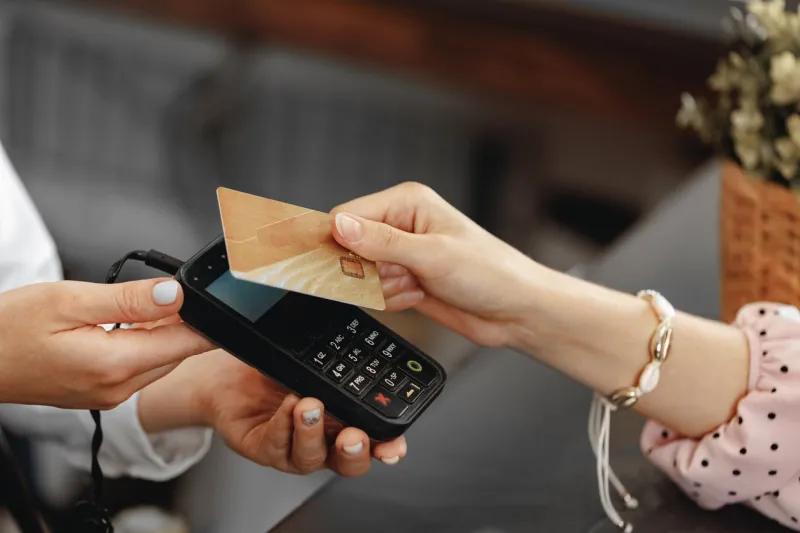 close up photo of hand of customer paying with contactless credit card