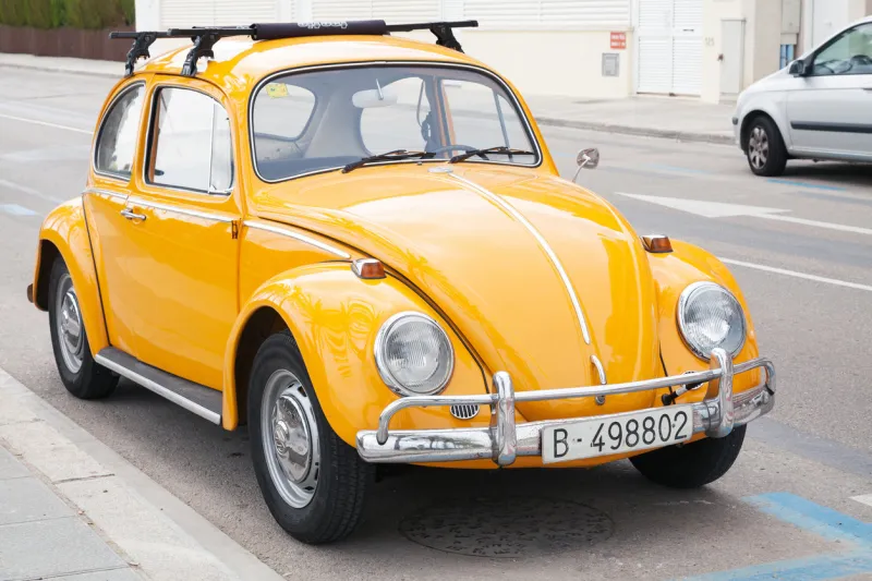 calafel, spain - august 20, 2014  yellow volkswagen kafer stands parked on the roadside