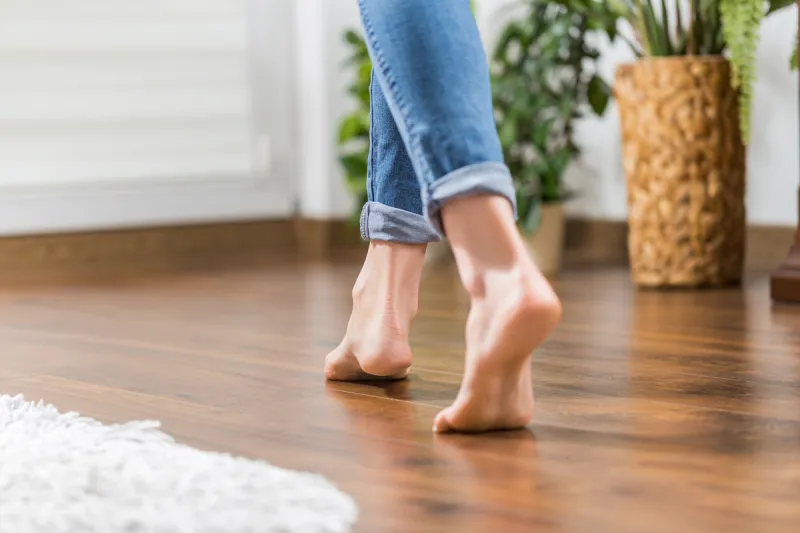 floor heating young woman walking in the house on the warm floor gently walked the wooden panels