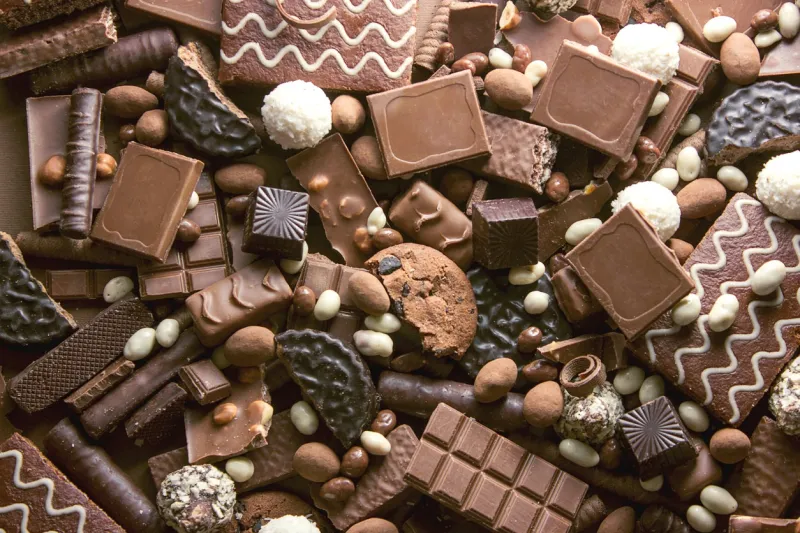 chocolate background many pieces of chocolate, candies, cookies, biscuits, cakes and other sweets milk chocolate and dark chocolate coconut candy