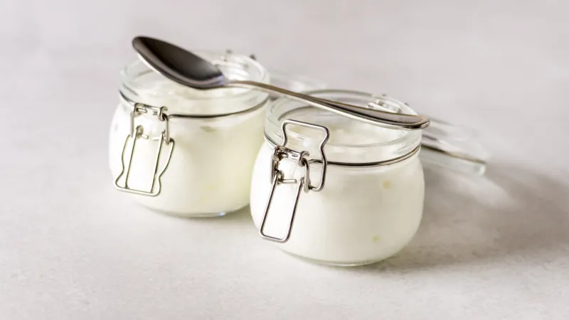 homemade greek yogurt in a glass jars ready to eat healthy breakfast banner