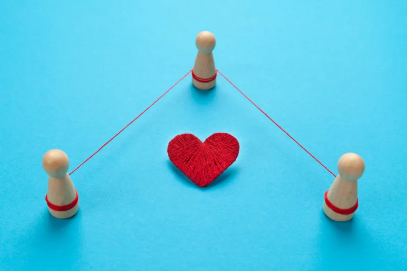 three people in a love story betrayal and treason in the family, concept figures of people are tied with a thread on a blue background