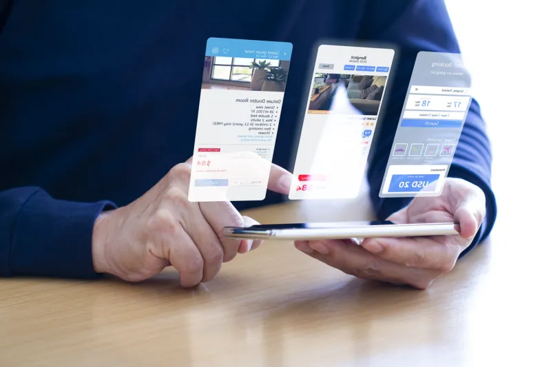 man in blue t-shirt planning a trip by making a reservation via internet hotel online booking application