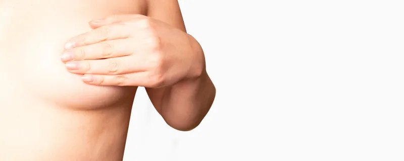 close up cropped portrait young woman with breast pain touching chest