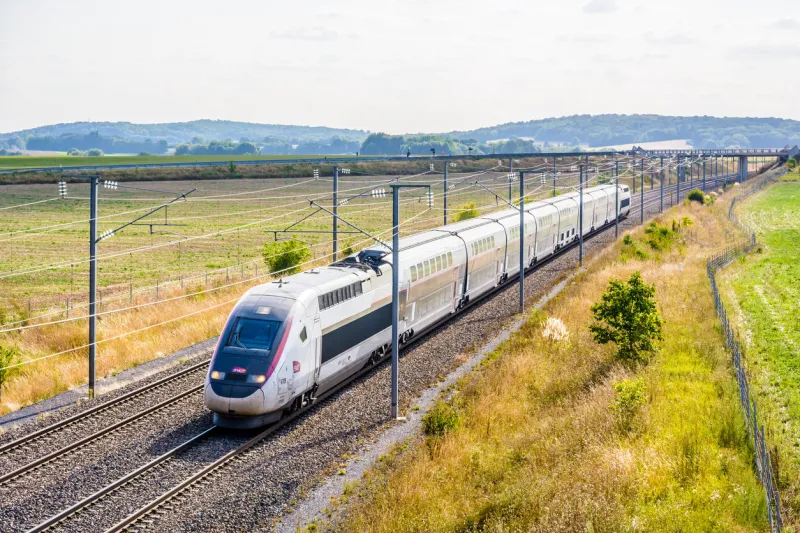 varreddes, france - august 18, 2018  a tgv duplex high speed train in carmillon livery from french company sncf driving on the lgv est, the east european high speed railway line, in the countryside