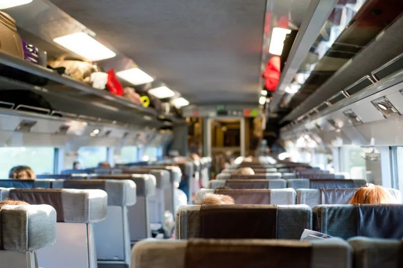 passenger's view of the interior of a train with people travelling