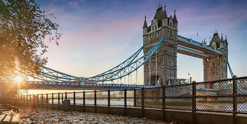 the tower bridge in london, united kingdom, during a golden sunrise