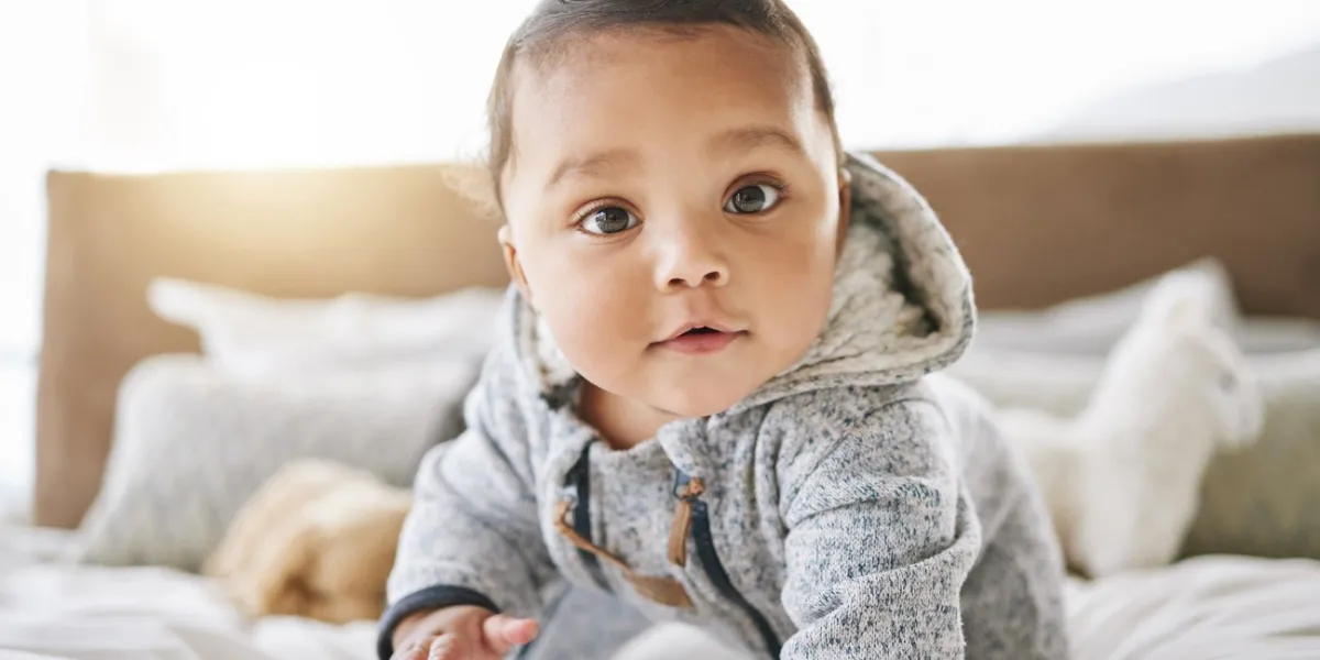 shot of an adorable baby boy playing on the bed at home
